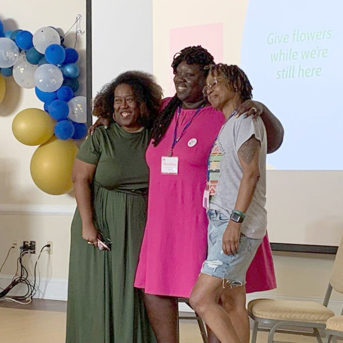 Kamaria, Mandisa and Venita receive flowers at the Black Leadership Institute.